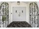 Elegant front entrance with custom wrought iron door and decorative black and marble tile flooring at 15722 Gardenside Ln, Tampa, FL 33624