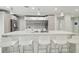 Modern kitchen features an island with bar stool seating, and stainless steel appliances at 15722 Gardenside Ln, Tampa, FL 33624