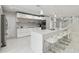 Modern kitchen features an island with bar stool seating, pendant lighting, and stainless steel appliances at 15722 Gardenside Ln, Tampa, FL 33624