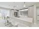 A modern kitchen features a large island with bar stool seating and stainless steel appliances at 15722 Gardenside Ln, Tampa, FL 33624