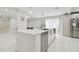 Modern kitchen featuring stainless steel appliances and a large center island at 15722 Gardenside Ln, Tampa, FL 33624