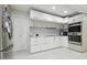 Modern kitchen design with stainless steel appliances and sleek white cabinetry at 15722 Gardenside Ln, Tampa, FL 33624