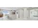 Bright kitchen boasts a large island with seating, modern white cabinets, and stainless steel appliances at 15722 Gardenside Ln, Tampa, FL 33624