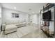 Bright living room featuring a sectional sofa, shelving and wood flooring at 15722 Gardenside Ln, Tampa, FL 33624