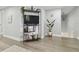 Inviting living room with stylish shelving unit, decorative plants, and modern flooring at 15722 Gardenside Ln, Tampa, FL 33624