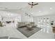 Spacious living room with vaulted ceilings, white tile floors and french doors leading to the backyard at 15722 Gardenside Ln, Tampa, FL 33624