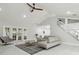Bright living room featuring high ceilings, stylish furnishings, and access to the backyard through French doors at 15722 Gardenside Ln, Tampa, FL 33624