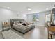 Serene main bedroom with tufted headboard, light-filled window, and modern furnishings at 15722 Gardenside Ln, Tampa, FL 33624