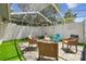 Enclosed outdoor patio with stone pavers, comfortable seating, and a privacy wall at 15722 Gardenside Ln, Tampa, FL 33624