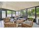 Enclosed sunroom featuring comfortable seating and views of the outdoors at 15722 Gardenside Ln, Tampa, FL 33624