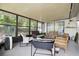 Enclosed sunroom featuring comfortable seating and views of the outdoors at 15722 Gardenside Ln, Tampa, FL 33624