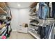 Well-organized walk-in closet with custom shelving, hanging racks, and ample storage space at 15722 Gardenside Ln, Tampa, FL 33624