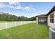 Spacious backyard with lawn, a fence, and a screened-in patio at 1827 Trillium Blvd, Brooksville, FL 34604