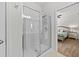 Bright bathroom featuring a glass-enclosed shower and tile flooring at 1827 Trillium Blvd, Brooksville, FL 34604