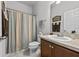 Bathroom with a single vanity and shower with striped shower curtain at 1827 Trillium Blvd, Brooksville, FL 34604