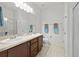 Clean bathroom featuring double vanity, tile flooring, and walk-in shower at 1827 Trillium Blvd, Brooksville, FL 34604