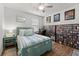 Bright bedroom with decor, wood-look flooring, ceiling fan, and shelving at 1827 Trillium Blvd, Brooksville, FL 34604