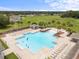 Aerial image of a community pool with zero entry, shaded cabanas, and abundant lounge chairs on a sunny day at 1827 Trillium Blvd, Brooksville, FL 34604