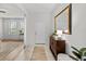 Bright foyer with tile flooring, large mirror, console table, and view to the living area at 1827 Trillium Blvd, Brooksville, FL 34604