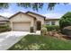 Inviting single-story home featuring a well-maintained lawn and a two car garage at 1827 Trillium Blvd, Brooksville, FL 34604