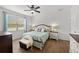 Bright main bedroom with ceiling fan, wood floor, and view to a window at 1827 Trillium Blvd, Brooksville, FL 34604