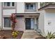Inviting front entrance adorned with vibrant plants and tasteful decor at 1830 Cypress Trace Dr, Safety Harbor, FL 34695
