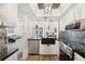 Contemporary kitchen with stainless steel appliances, mosaic backsplash, flows into dining and living areas at 1830 Cypress Trace Dr, Safety Harbor, FL 34695