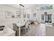 Bright living and dining space with wood floors, modern light fixture, and access to the lanai at 1830 Cypress Trace Dr, Safety Harbor, FL 34695