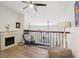 Loft features a fireplace, high ceilings, and a railing overlooking the living space at 1830 Cypress Trace Dr, Safety Harbor, FL 34695