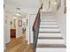Open staircase with wood and white finishes, leading to the second floor and access to the bathroom at 1830 Cypress Trace Dr, Safety Harbor, FL 34695