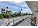 Enjoy the beautiful blue sky on this gorgeous balcony with amazing views of the neighborhood at 19111 Whispering Pines Dr, Indian Shores, FL 33785
