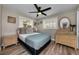 Comfortable bedroom featuring natural light, plank flooring, and tasteful decor, creating a serene retreat at 19111 Whispering Pines Dr, Indian Shores, FL 33785