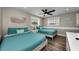 Bright bedroom with two beds, plank flooring, and sunny windows, providing ample space and comfort at 19111 Whispering Pines Dr, Indian Shores, FL 33785