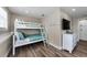 Charming bunk room with a bunk bed, dresser, and wood-look floors, perfect for or guests at 19111 Whispering Pines Dr, Indian Shores, FL 33785