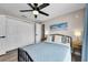 Cozy bedroom with a ceiling fan, closet, and soft natural light creating a relaxing space at 19111 Whispering Pines Dr, Indian Shores, FL 33785