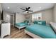 Bright bedroom with two beds, plank flooring, and sunny windows, providing ample space and comfort at 19111 Whispering Pines Dr, Indian Shores, FL 33785