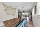 Open dining area with wood floors, a large table, and a view into the living room at 19111 Whispering Pines Dr, Indian Shores, FL 33785