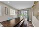 Light-filled dining room with a large table, wooden bench, and coastal decor at 19111 Whispering Pines Dr, Indian Shores, FL 33785