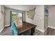 Charming dining room featuring a large wood table and bright blue chairs at 19111 Whispering Pines Dr, Indian Shores, FL 33785