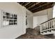 Ground floor showcasing stairs to the upper level and a white painted interior at 19111 Whispering Pines Dr, Indian Shores, FL 33785