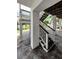 Ground level showing stairs to the upper level and concrete flooring at 19111 Whispering Pines Dr, Indian Shores, FL 33785
