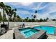 Inviting backyard pool, hot tub, grill, and ample seating for outdoor entertaining at 19111 Whispering Pines Dr, Indian Shores, FL 33785