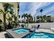 Inviting backyard pool, hot tub, grill, and ample seating for outdoor entertaining at 19111 Whispering Pines Dr, Indian Shores, FL 33785