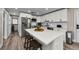 Stylish kitchen with stainless appliances, white cabinets, and a functional island with barstool seating at 19111 Whispering Pines Dr, Indian Shores, FL 33785