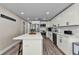 Modern kitchen with white cabinetry, stainless steel appliances, and a large island at 19111 Whispering Pines Dr, Indian Shores, FL 33785