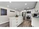 Bright kitchen featuring white cabinetry, stainless steel appliances, and a center island at 19111 Whispering Pines Dr, Indian Shores, FL 33785