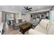 Spacious living room and kitchen with wood floors and a coastal-themed decor at 19111 Whispering Pines Dr, Indian Shores, FL 33785