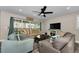 Bright living room with a coastal feel, featuring large windows and comfortable seating at 19111 Whispering Pines Dr, Indian Shores, FL 33785