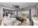 Comfortable living room leading to a modern kitchen, featuring a large sliding glass door at 19111 Whispering Pines Dr, Indian Shores, FL 33785