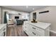 Open concept living room with hardwood flooring, modern furnishings, and neutral paint at 19111 Whispering Pines Dr, Indian Shores, FL 33785